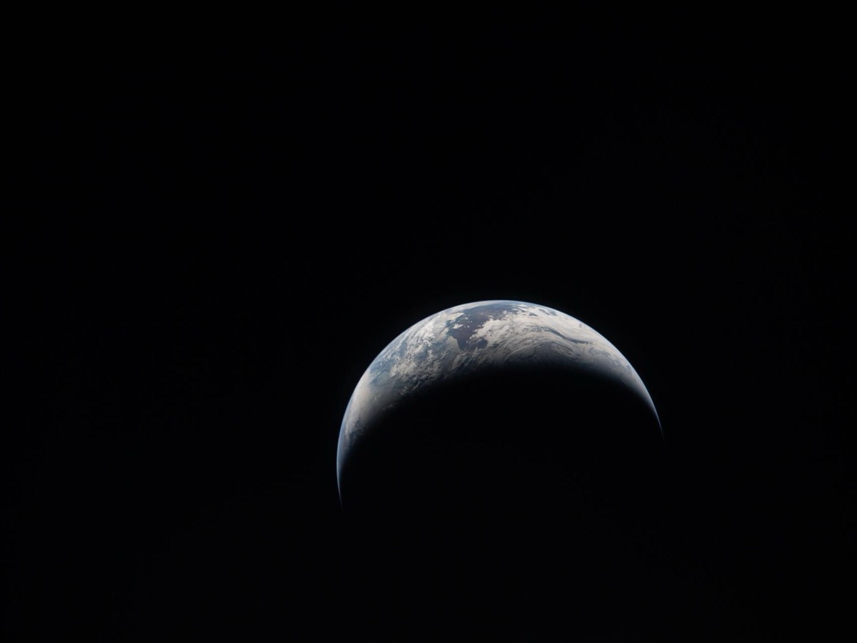 Croissant de Terre éclairé sur fond noir, photographié depuis l'espace