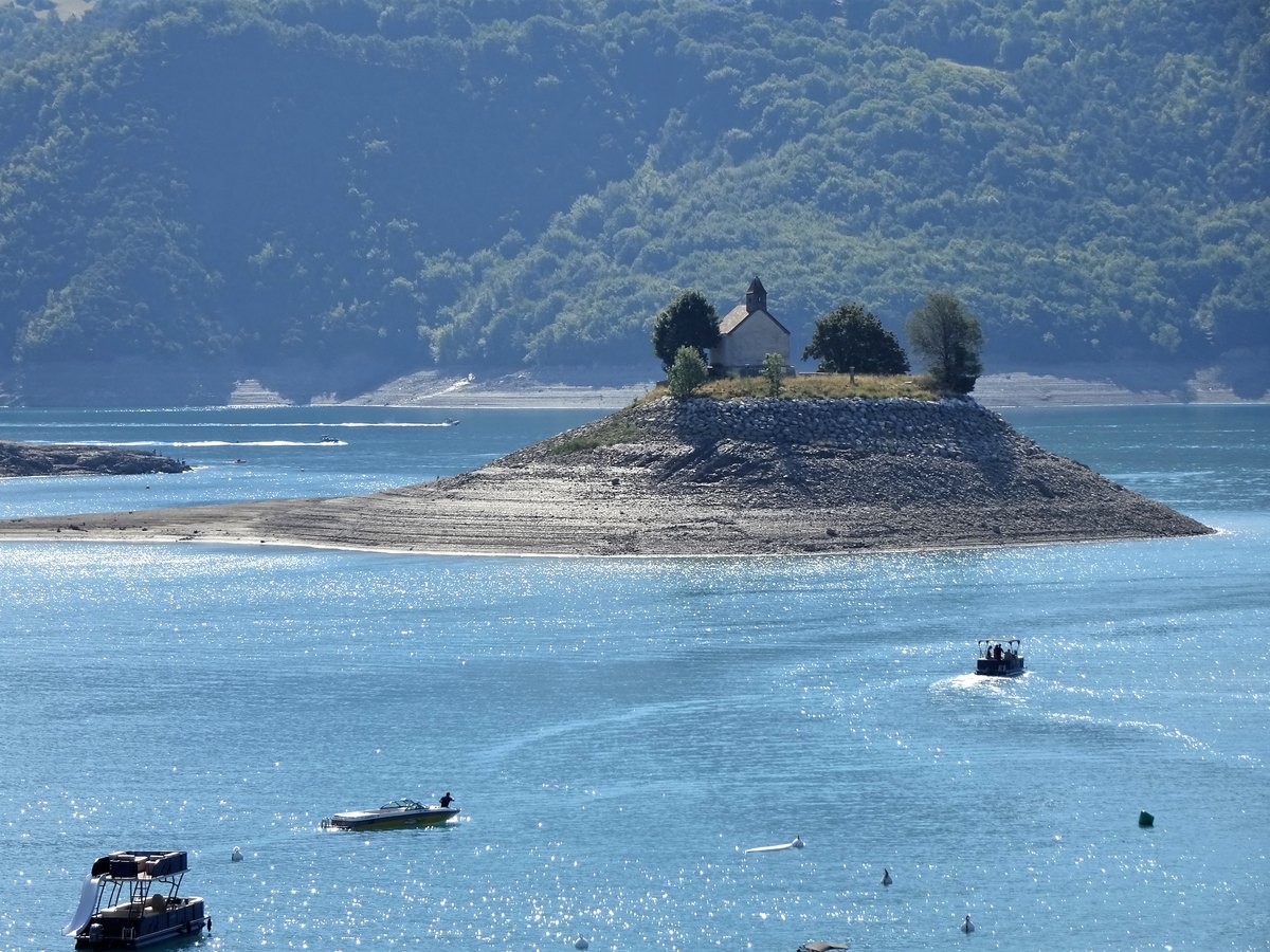 La chapelle Saint-Michel sur son îlot, entourée de berges découvertes par la baisse du lac de Serre-Ponçon